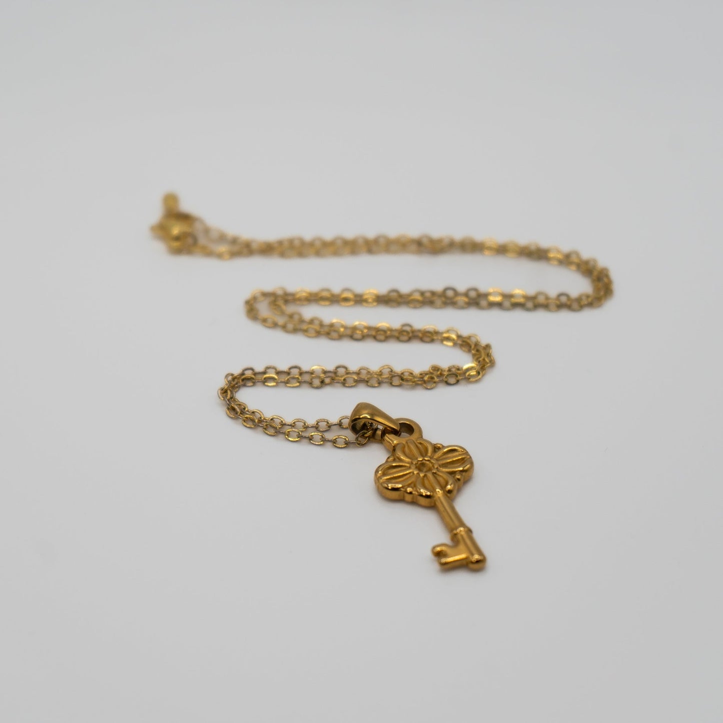 Lula Sea Jewellery New Zealand, Journey key necklace, 18k Gold plated necklace featuring a ornate key pendant pictured on flat surface