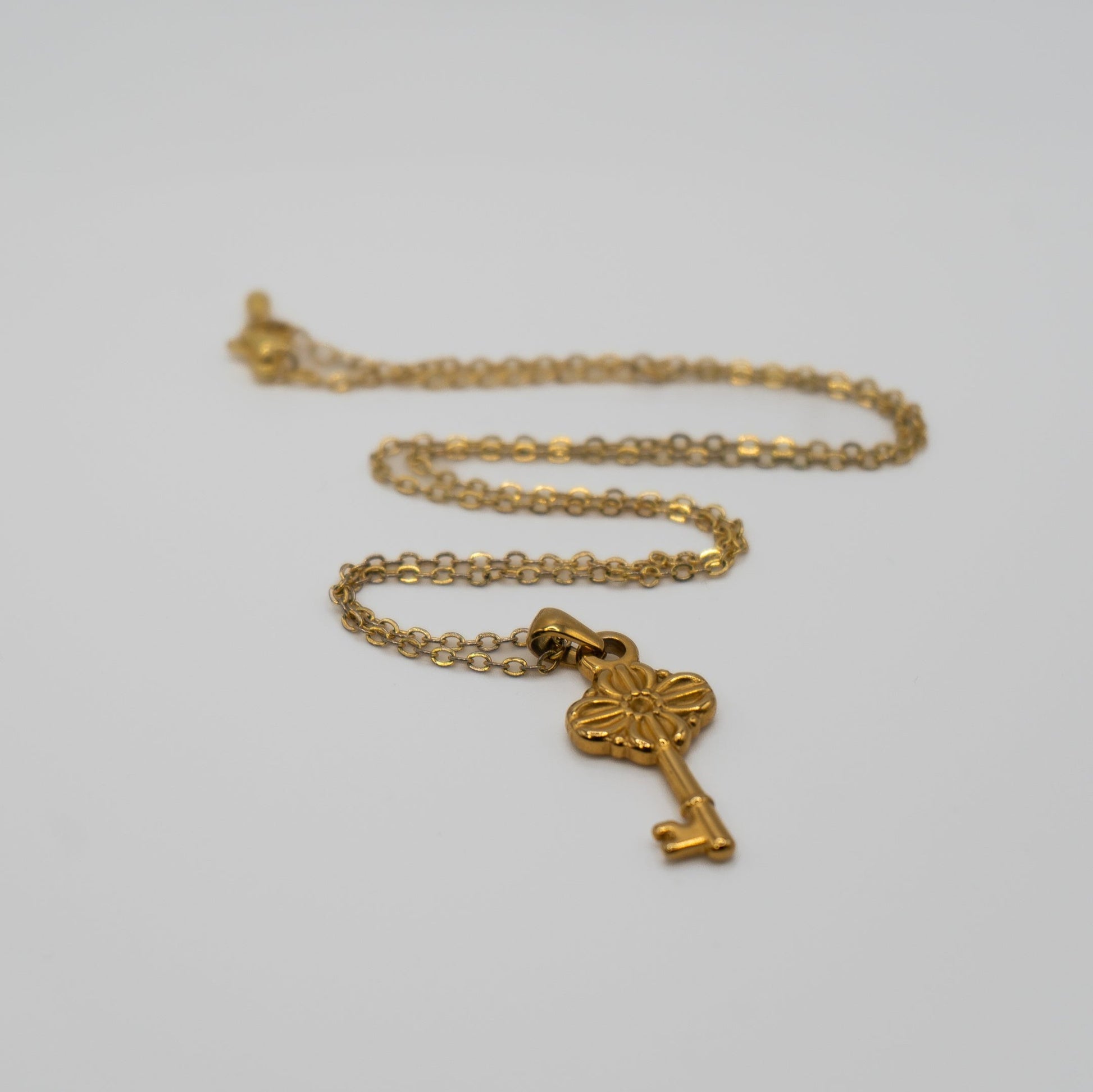 Lula Sea Jewellery New Zealand, Journey key necklace, 18k Gold plated necklace featuring a ornate key pendant pictured on flat surface