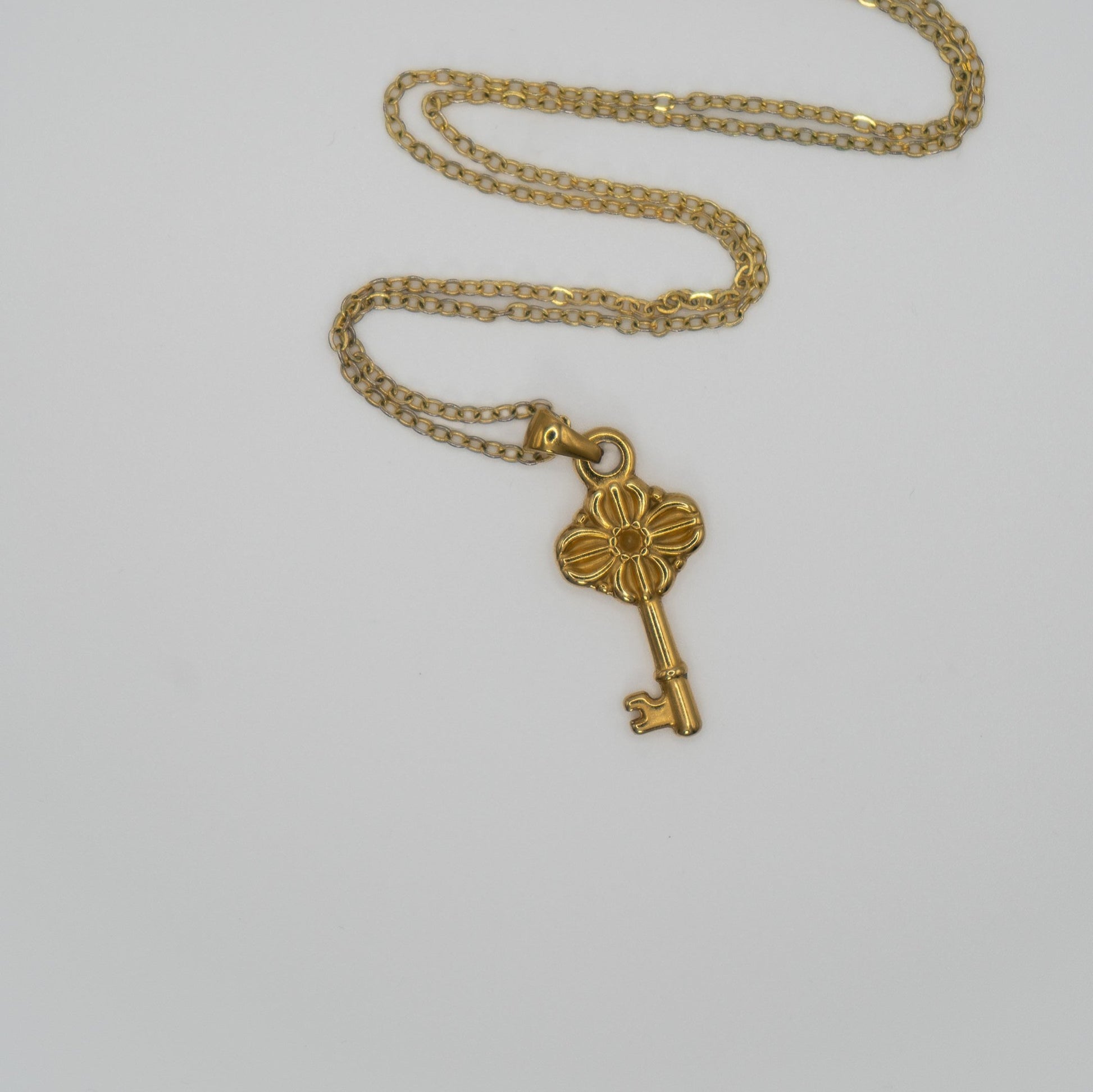 Lula Sea Jewellery New Zealand, Journey key necklace, 18k Gold plated necklace featuring a ornate key pendant pictured on flat surface