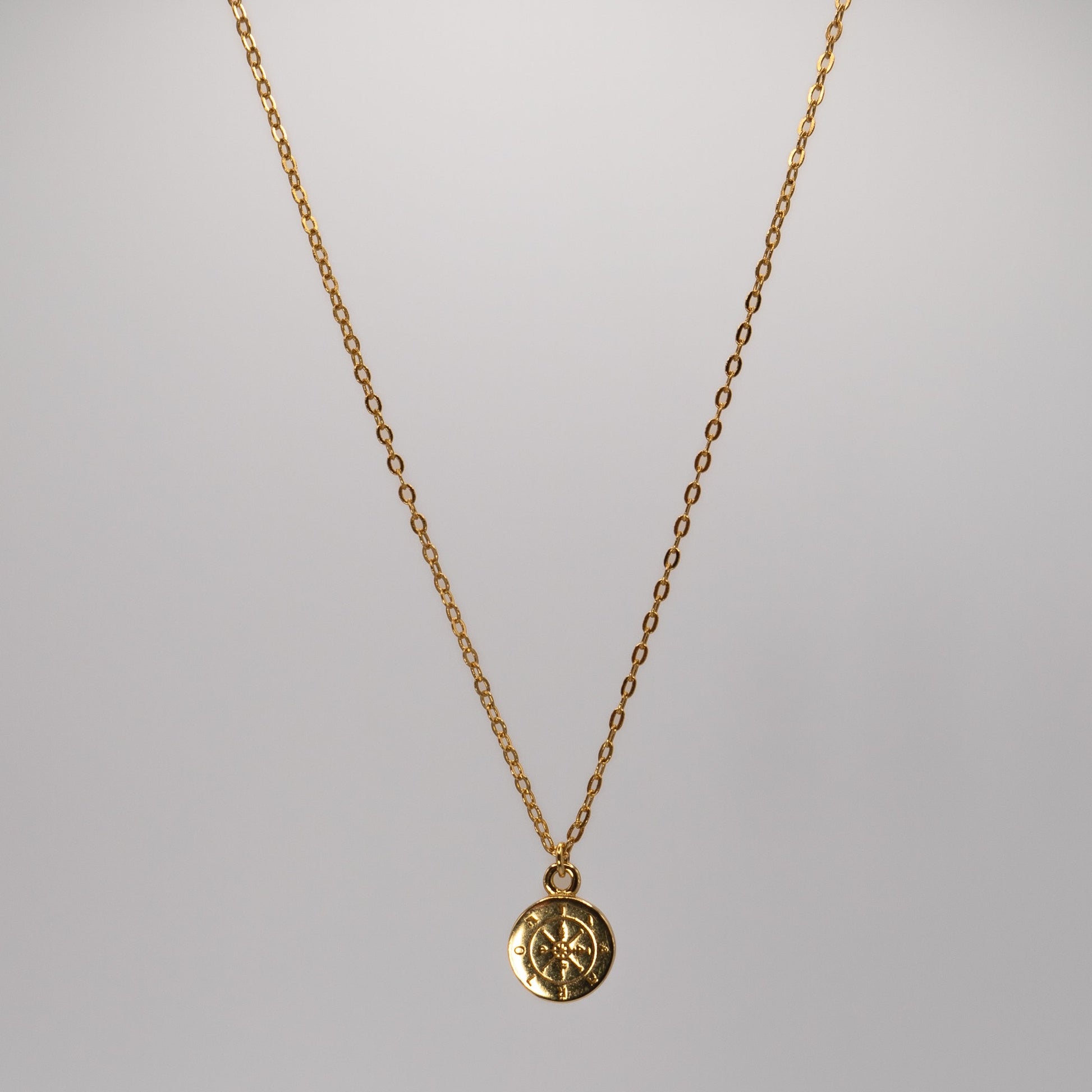 ula Sea Jewellery journey pendant necklace, in 18k gold vermeil, necklace features a tiny golden compass hanging from a delicate gold chain View of necklace hanging 