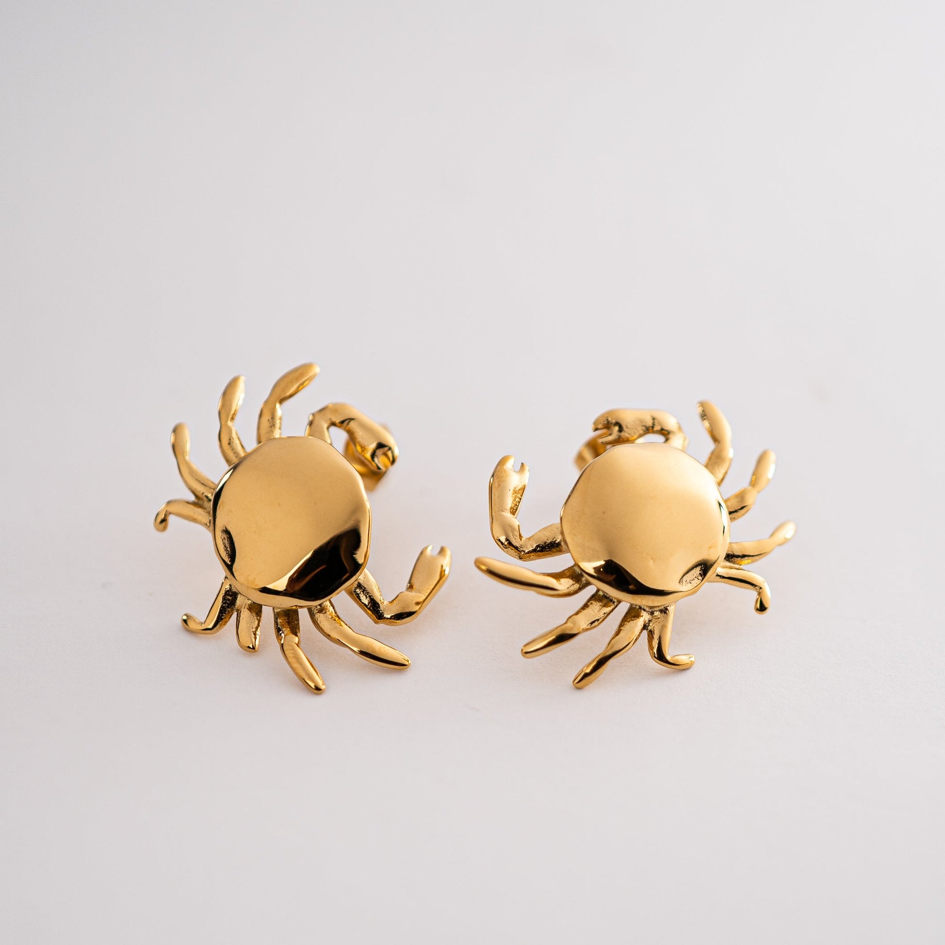 Lula Sea Jewellery, 18k gold plated pincer stud earrings, small golden crab earrings, studs earrings, crab hangs from one pincer attached to the stud.