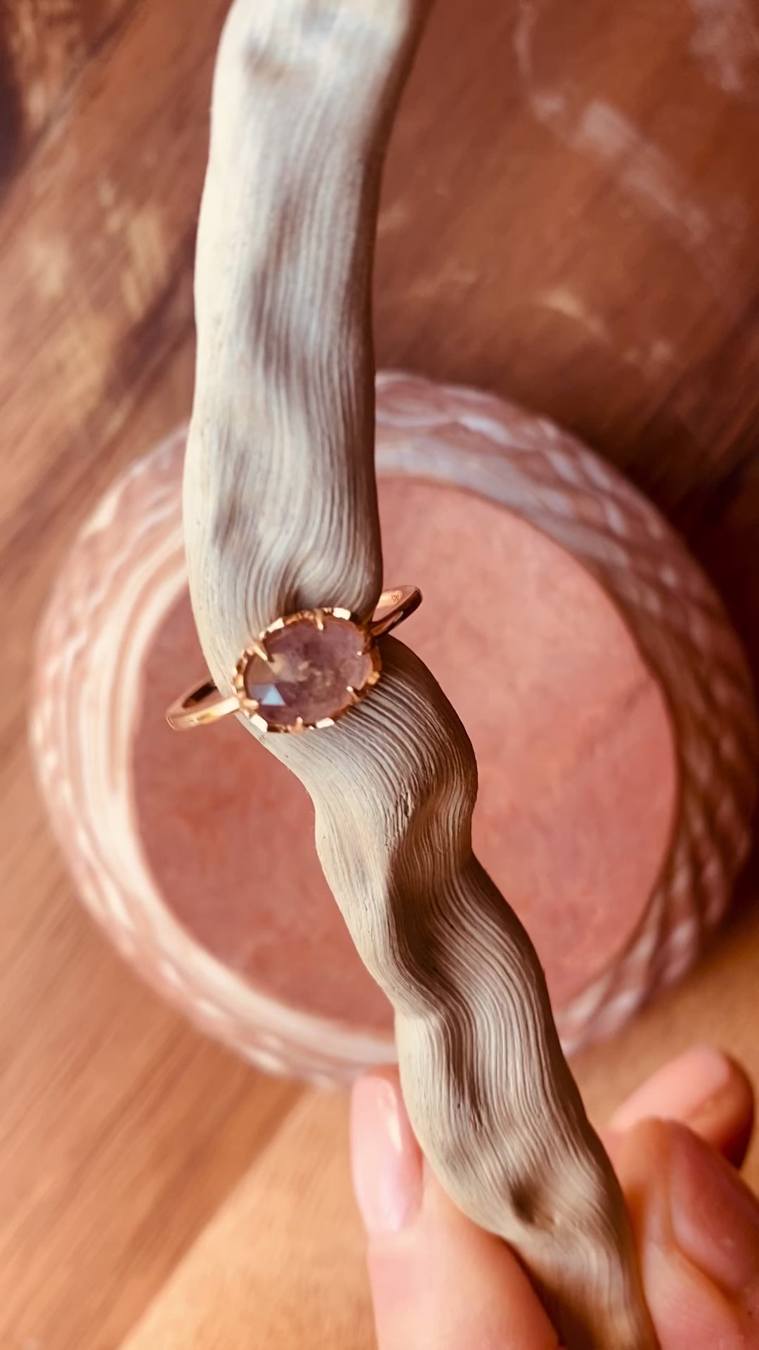 Lula Sea Jewellery New Zealand, Sugarplum ring, video of on a pice of drift wood, slowly turning in the light showing the blue flash of the strawberry labradorite faucet cut gemstone. Ring made from Gold vermeil